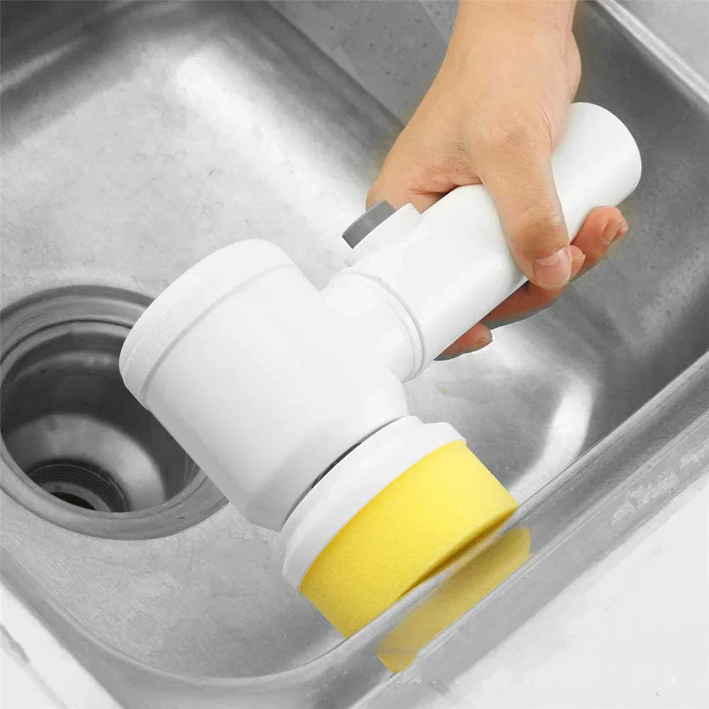 Hand holding a white and yellow cleaning tool over a sink