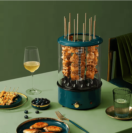 Blue skewer grill with food on a green table setting with a glass of wine.