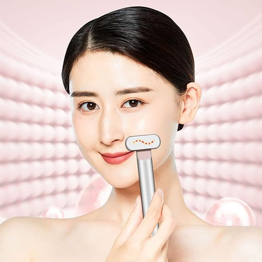 Woman using a skincare device on her face with a pink background